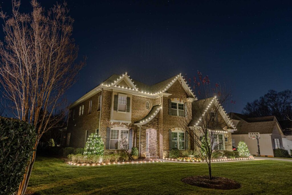 Holiday light installation with roofline and landscape lighting